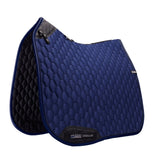 Blue quilted saddle pad with black accents on a white background