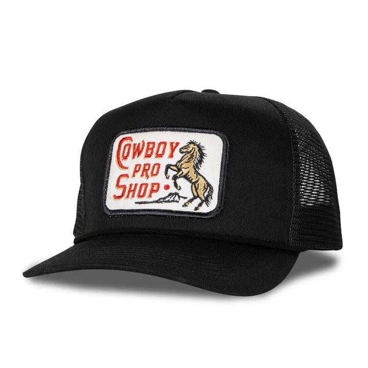 Black trucker hat with a 'Cowboy Pro Shop' patch featuring a horse on a white background